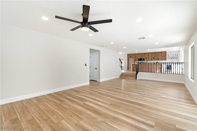 empty room featuring recessed lighting, baseboards, visible vents, and light wood finished floors