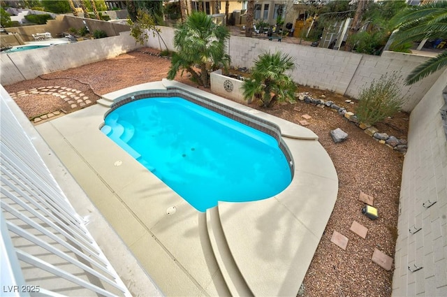 view of pool with a fenced backyard