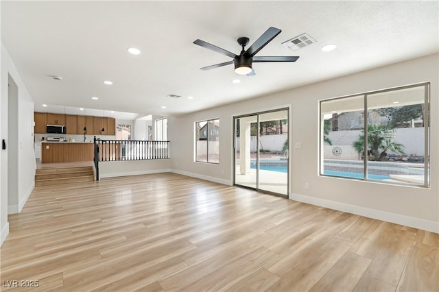 unfurnished living room featuring light wood-type flooring, visible vents, and recessed lighting