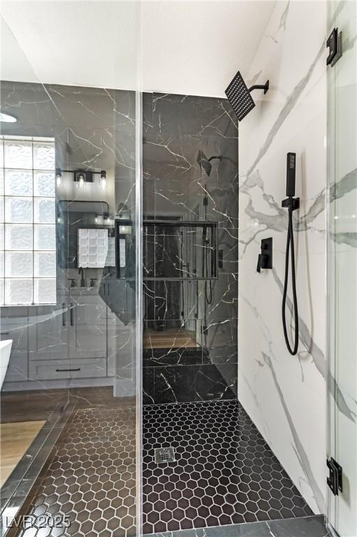 full bath featuring a marble finish shower