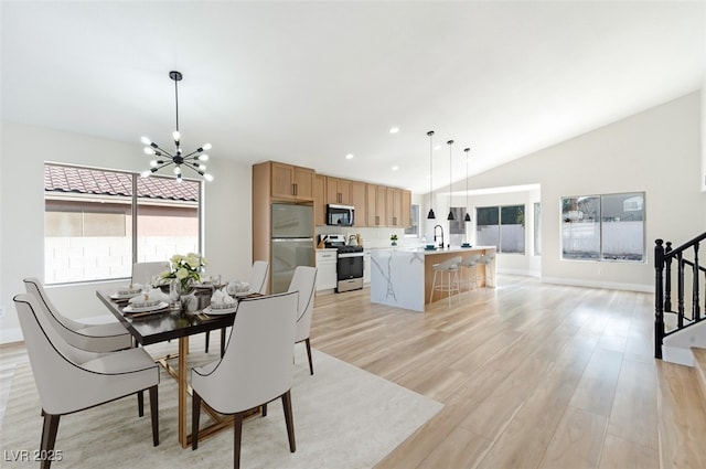 dining room with recessed lighting, light wood-style flooring, an inviting chandelier, vaulted ceiling, and stairs