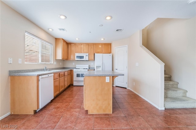 kitchen featuring a breakfast bar area, recessed lighting, white appliances, visible vents, and a center island