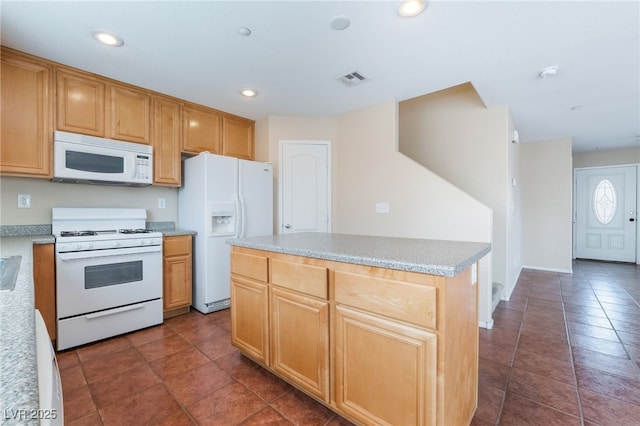 kitchen featuring white appliances, visible vents, a kitchen island, light countertops, and recessed lighting