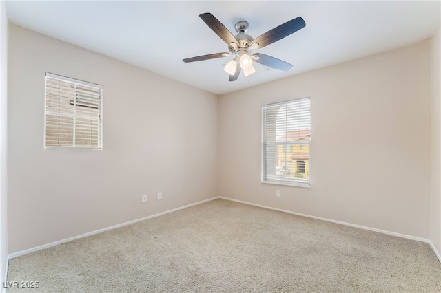 unfurnished room featuring a ceiling fan, carpet, and baseboards