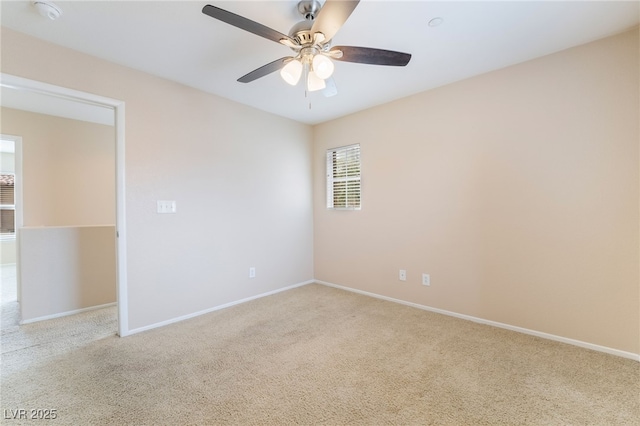 spare room with ceiling fan, baseboards, and carpet flooring