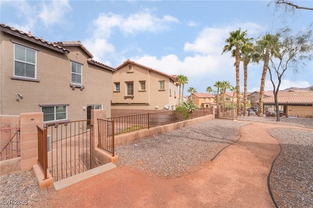 exterior space featuring a patio area, fence, and a residential view