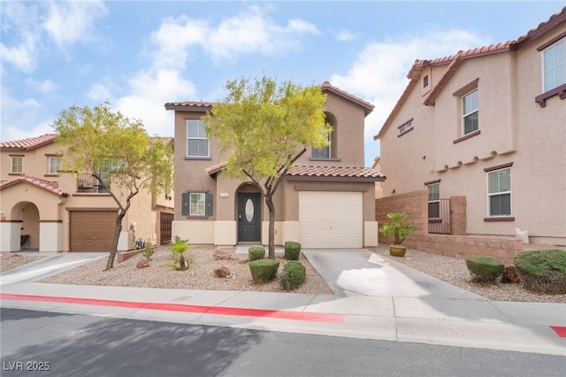 mediterranean / spanish-style house with a garage, driveway, a tiled roof, and stucco siding