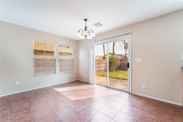 spare room with baseboards, tile patterned floors, visible vents, and a notable chandelier