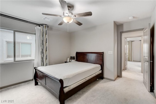 bedroom featuring light carpet, baseboards, visible vents, and a ceiling fan