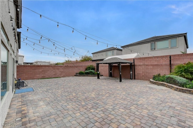 view of patio featuring a gazebo and a fenced backyard