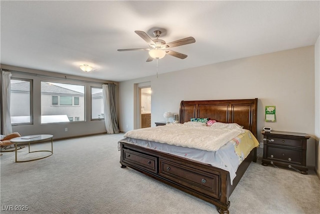 bedroom featuring ensuite bath, a ceiling fan, and light colored carpet