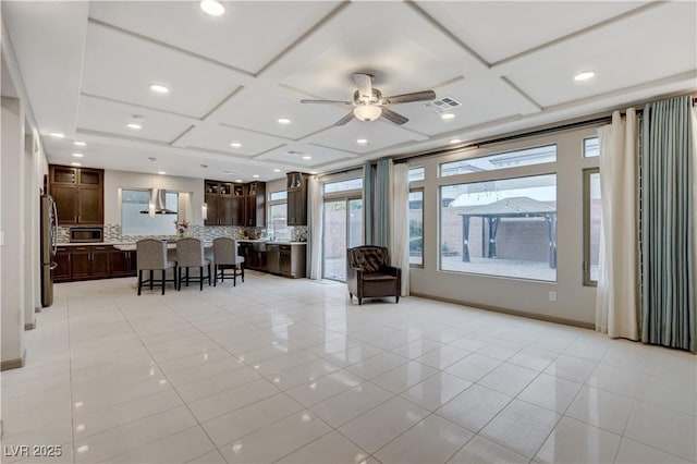 unfurnished living room with light tile patterned flooring, coffered ceiling, visible vents, and recessed lighting