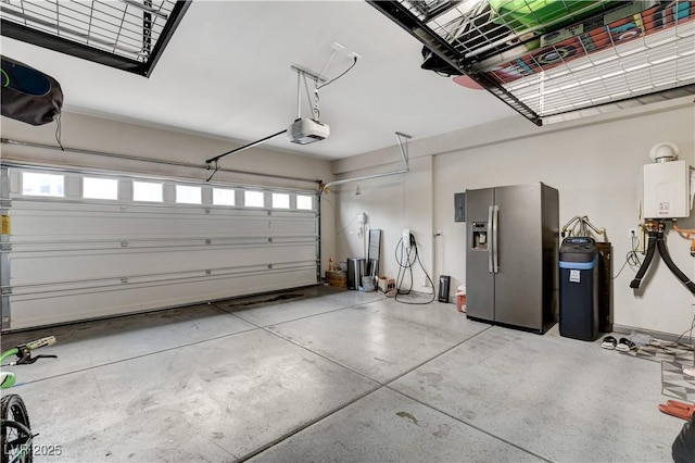 garage with a garage door opener, tankless water heater, and stainless steel fridge