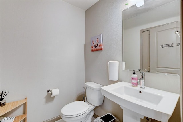 bathroom featuring a sink and toilet