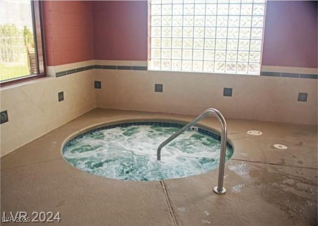 view of pool featuring an indoor hot tub