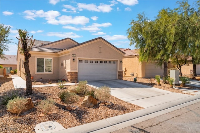 ranch-style home with stucco siding, a garage, stone siding, driveway, and a tiled roof