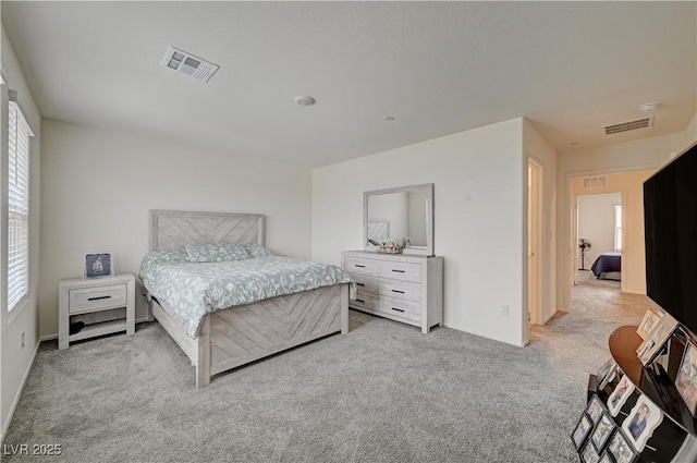 bedroom featuring light colored carpet and visible vents