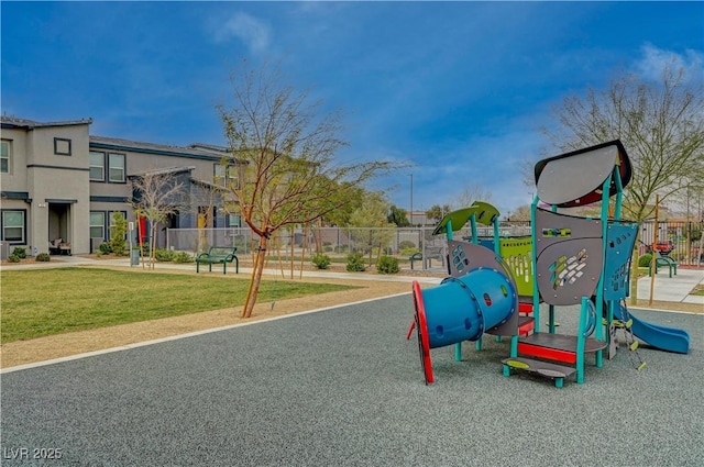 community play area with fence and a lawn