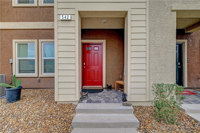 property entrance featuring stucco siding