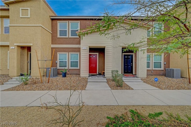 townhome / multi-family property featuring stucco siding and central air condition unit