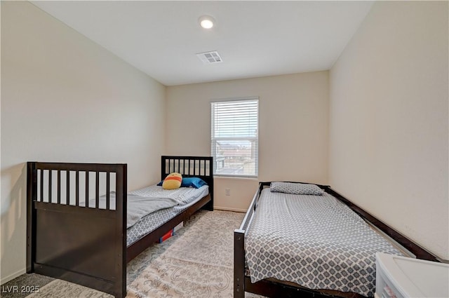 bedroom with carpet flooring, visible vents, and baseboards