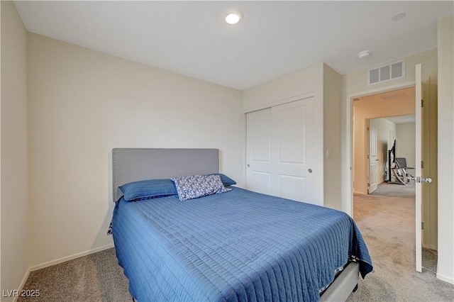 carpeted bedroom featuring baseboards, visible vents, and a closet