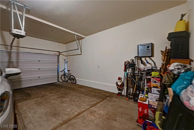 garage featuring a garage door opener and baseboards