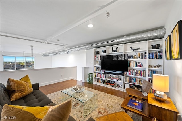 living room with baseboards and wood finished floors