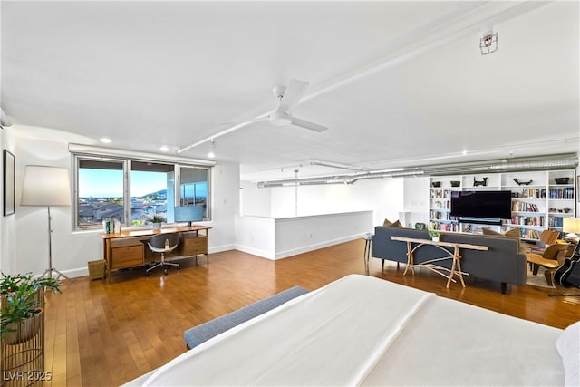 bedroom featuring baseboards, ceiling fan, and hardwood / wood-style floors