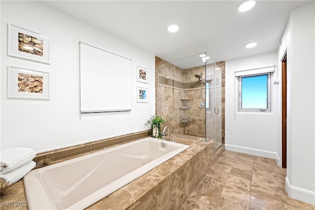 bathroom with a stall shower, a garden tub, baseboards, and recessed lighting