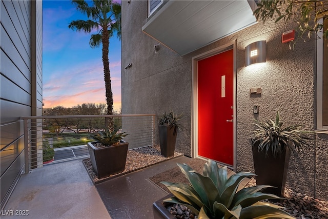 entrance to property featuring stucco siding