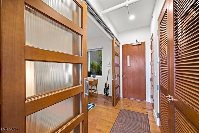 foyer entrance featuring light wood-style floors