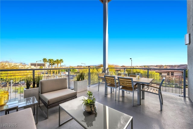 view of patio / terrace featuring a balcony and outdoor dining area