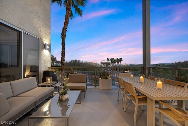 patio terrace at dusk with an outdoor hangout area and outdoor dining space