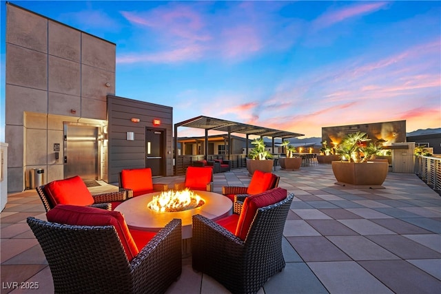 view of patio featuring an outdoor fire pit and elevator