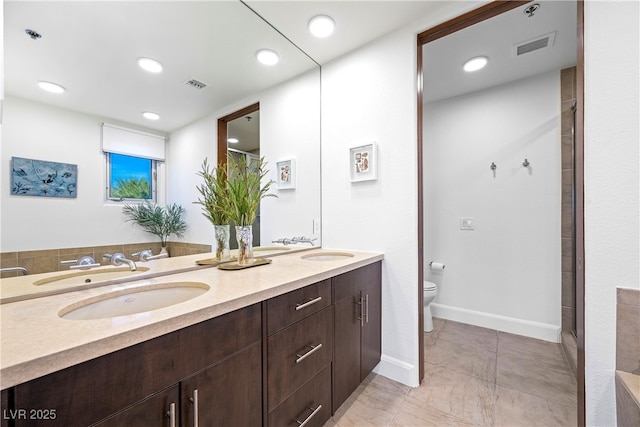 full bathroom featuring toilet, double vanity, visible vents, and recessed lighting