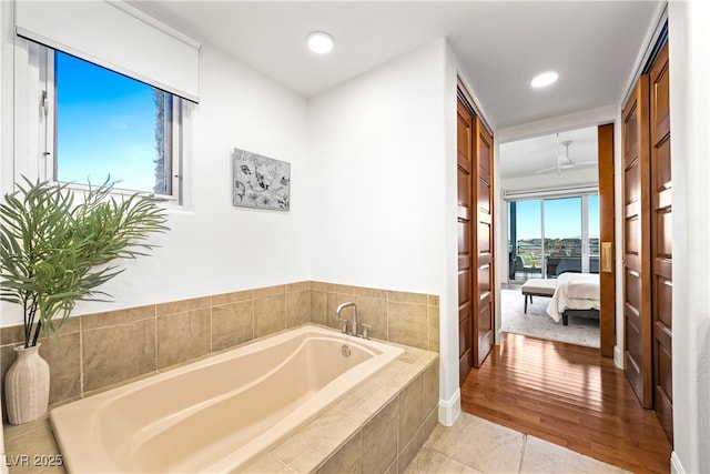 ensuite bathroom with tile patterned flooring, ensuite bath, a bath, and recessed lighting