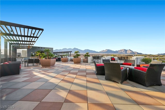 view of patio / terrace with a mountain view, outdoor dining area, and a pergola