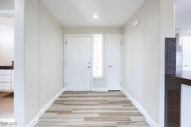 interior space featuring light wood-type flooring and baseboards