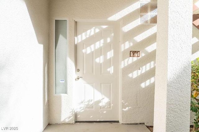 property entrance featuring stucco siding