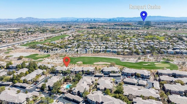 aerial view with view of golf course and a mountain view