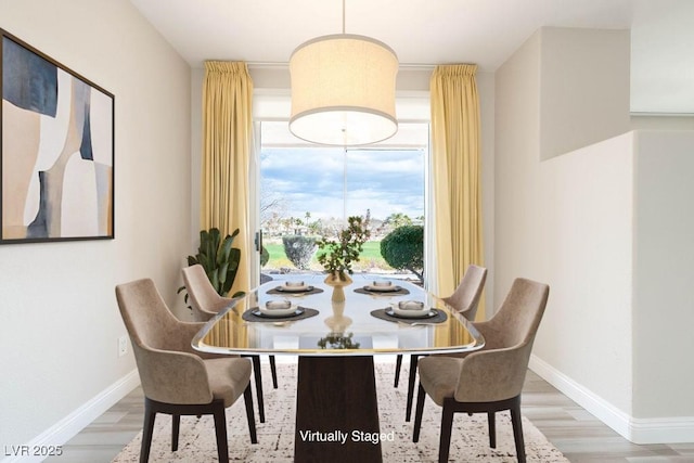 dining room with wood finished floors and baseboards