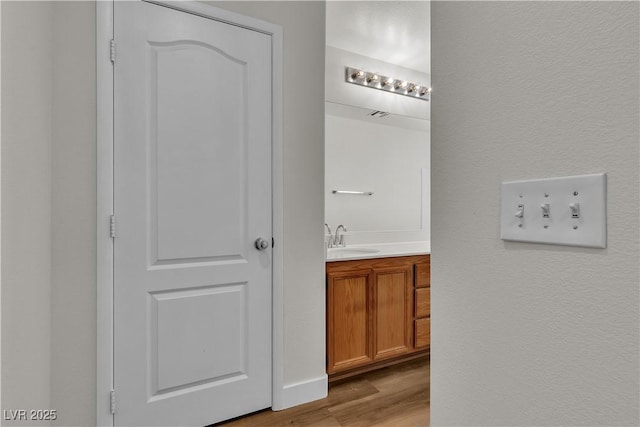 interior space with a sink and light wood-style flooring