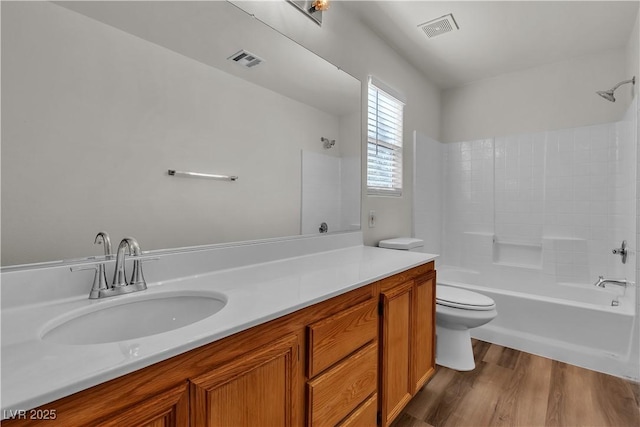full bath with shower / bath combination, toilet, wood finished floors, and visible vents