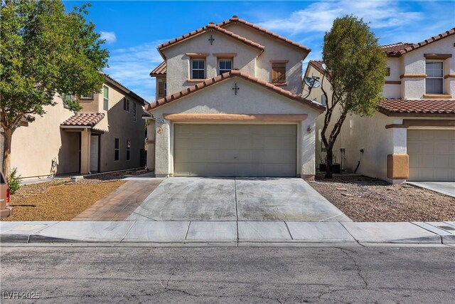 mediterranean / spanish-style house featuring a tiled roof, driveway, and stucco siding