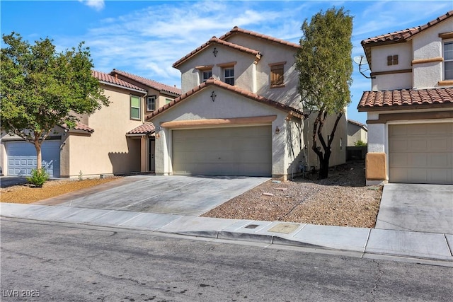 mediterranean / spanish house featuring driveway, a tile roof, and stucco siding