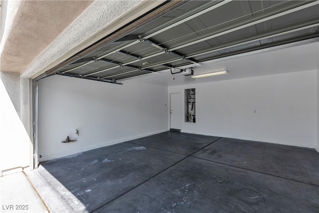 garage with baseboards and a garage door opener