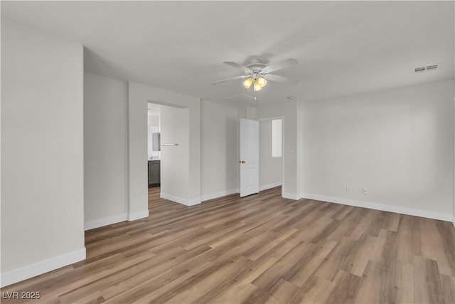 unfurnished bedroom with baseboards, ceiling fan, light wood-type flooring, and visible vents