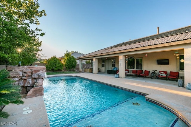 view of pool with a patio, outdoor lounge area, and a fenced in pool