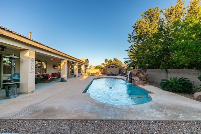 view of swimming pool with a patio, a fenced backyard, an outdoor structure, a fenced in pool, and a shed